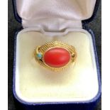 18ct gold coral ring set with central coral stone measures approx 12mm by 9mm with small turquoise s