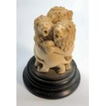 Indian ivory or bone figure on stand of 3 lions entwined standing on wooden base height approx 10cm