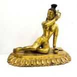 Tibet or Nepal finely cast and chased gilt bronze reclining female figure, beside a kapala, on plint