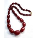 Fine Cherry amber / bakelite necklace good internal streaking largest bead meaures approx. 33mm by 2
