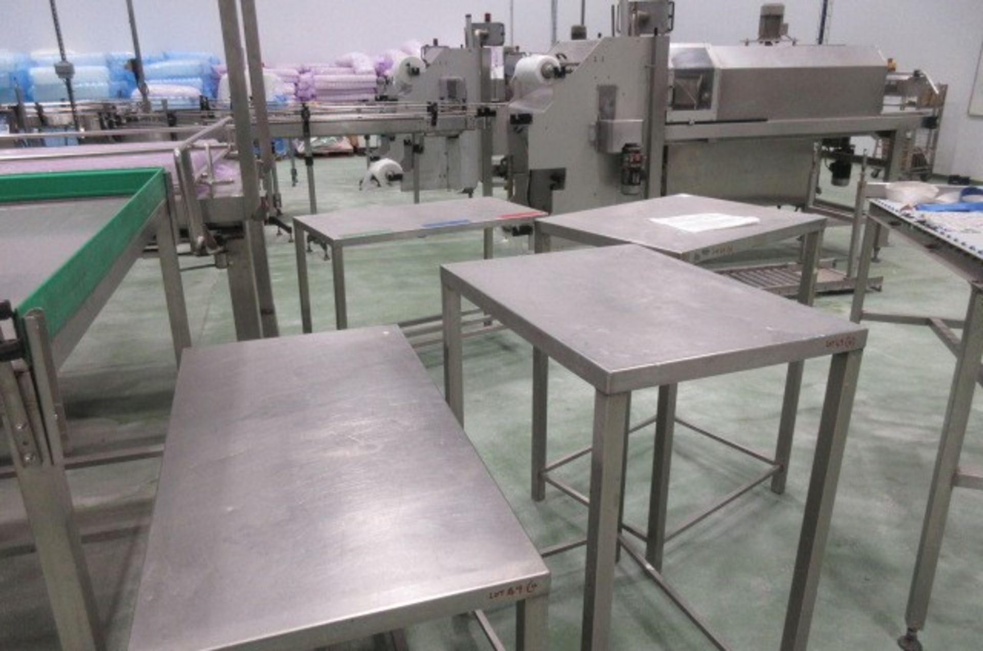 Four stainless steel table of assorted sizes.