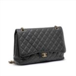 Chanel - a caviar Maxi Classic Single Flap handbag.