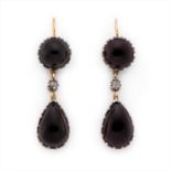 A pair of garnet and diamond earrings.