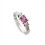 An 18ct gold pink sapphire and diamond three-stone ring.