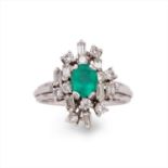 An emerald and diamond cluster ring.