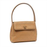 Chanel - a beige leather handbag.