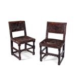 A pair of Charles II brass-studded leather upholstered chairs, circa 1660