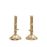 A pair of brass ejector candlesticks, English, early 18th century