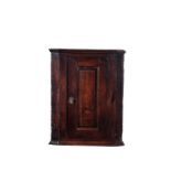 A George II oak hanging corner cupboard, possibly Welsh, circa 1740