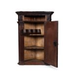 A George III oak architectural hanging corner cupboard, circa 1770