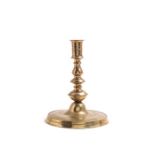 A large brass candlestick, dated 1612