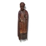 An English polychrome pine figure of a Bishop, early 17th century and a Gothic canopy