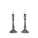 A pair of French bronze candlesticks with foliate socle bases, 19th century