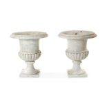 A pair of 19th century carved white veined marble Campana urns