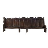 A large West Country oak wall settle, circa 1550
