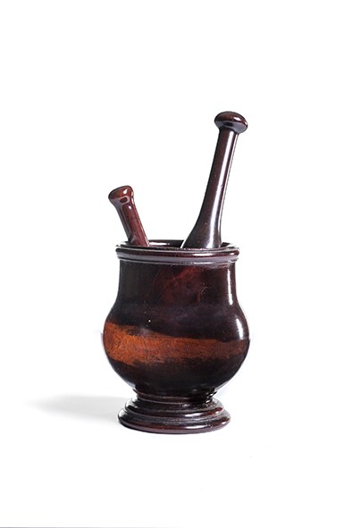 A George III lignum vitae mortar and pestle, circa 1780 and another pestle