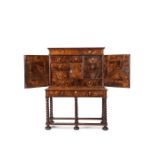 A Charles II walnut and featherbanded cabinet on stand, circa 1670