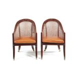 A pair of George IV simulated rosewood bergere chairs