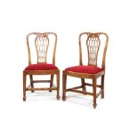 A pair of unusual George III fruitwood carved side chairs