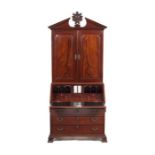 A George II carved mahogany bureau cabinet attributed to Gillows