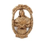 A large early 19th century carved beechwood roundel of a bust of a gentleman