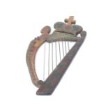 A late 19th century Irish folk art polychrome oak carved plaque in the form of a harp