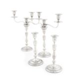A pair of George III silver three-light candelabra and a pair of candlesticks en suite