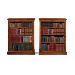 A pair of tall Victorian figured walnut open bookcases