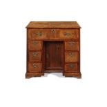 A George I walnut and ash banded kneehole desk