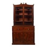 A Regency mahogany, tulipwood and sycamore banded secretaire bookcase in the manner of Gillows