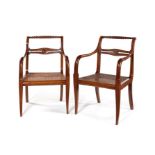 A pair of Empire carved mahogany open armchairs