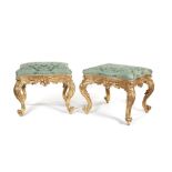 A pair of 19th century Louis XV style carved giltwood serpentine stools