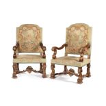 A large pair of late 19th century walnut and parcel gilt open armchairs in the Louis XIV style