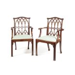 A pair of 19th century carved mahogany open armchairs in the George III style