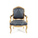 A mid 19th century Louis XV style carved gilt wood fauteuil à la reine