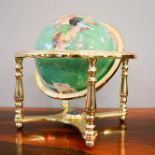 A gimble mounted world globe, inlaid with various specimen stones to form the countries, 31cm high.