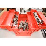 A metal tool box containing various sized spanners.