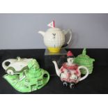 A group of novelty tea pots, to include golf ball teapot, motocar and clown example. (5)