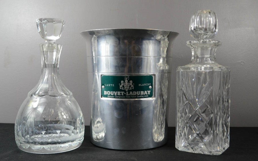 A Bouvet-Ladubay Champagne bucket together with two cut glass decanters, 27cm high.