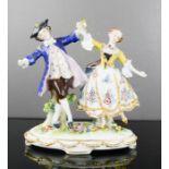 A French porcelain miniature figure group, depicting young lovers dancing, 13cm high.