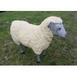 A lifesize model sheep, painted with detail.