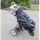 A Motocaddy electric gold buggy with golf clubs.