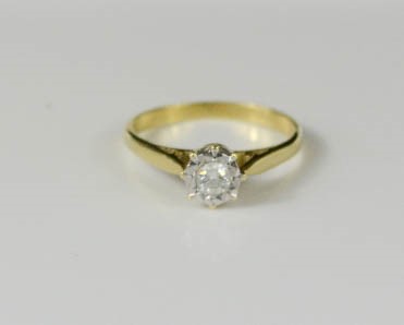 An 18ct gold and diamond solitaire ring, the diamond in a platinum setting, size O, 2.7g. - Image 2 of 2