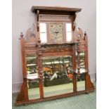 An Edwardian mahogany wall mirror with Art Nouveau central plaque.