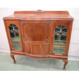 A mahogany glazed cabinet with domed front, stained glass panel doors, 111 by 117 by 42cm.