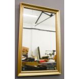 A rectangular gold painted wall mirror.