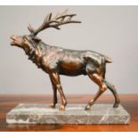 A copper model of a stag, raised on a grey marble base, 25cm high.