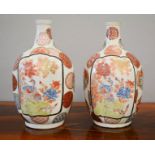 A pair of Chinese stoneware glazed bottle vases, painted with roundels and panels depicitng peacocks