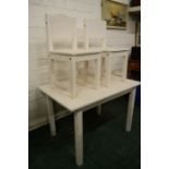 A child's table and matching chairs, painted white.