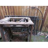 A singer sewing machine and a pair of gates, and a single metal gate.
